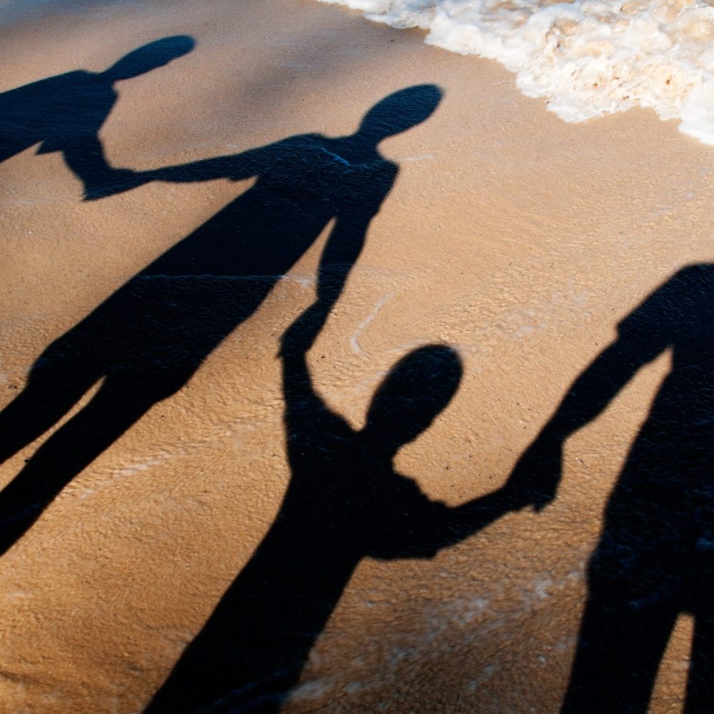 shadow-of-adults-and-children-holding-hands-on-the-2024-11-30-20-14-07-utc-min
