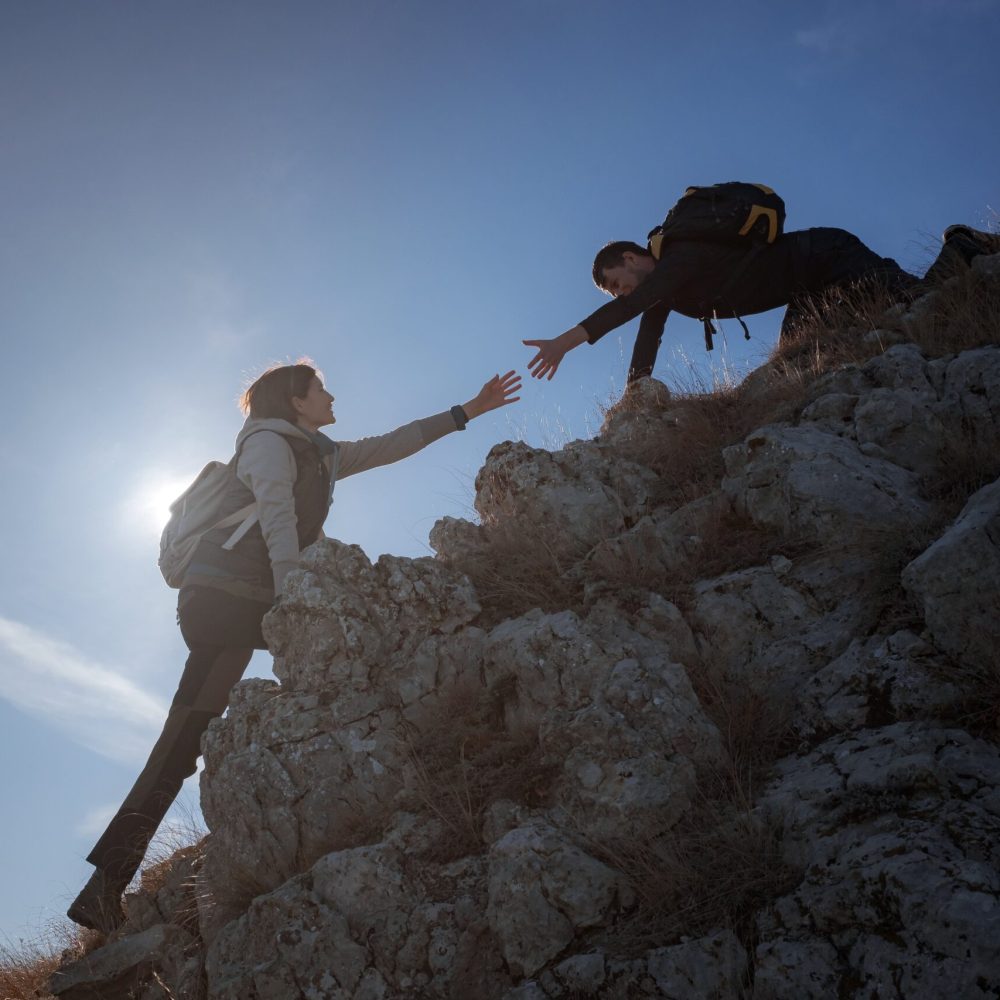 silhouettes-of-two-people-climbing-mountains-and-h-2025-01-16-10-16-23-utc-min